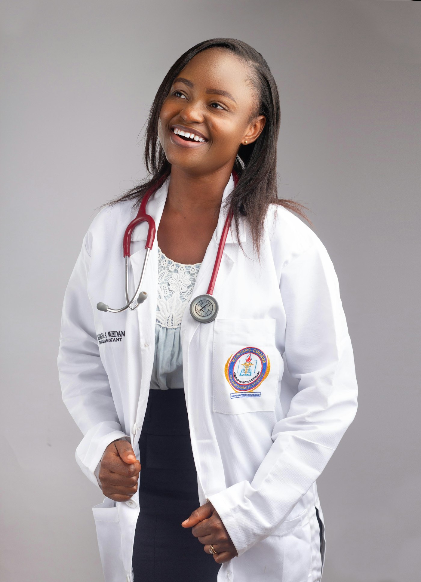 A Nigerian doctor in a white coat with a stethoscope