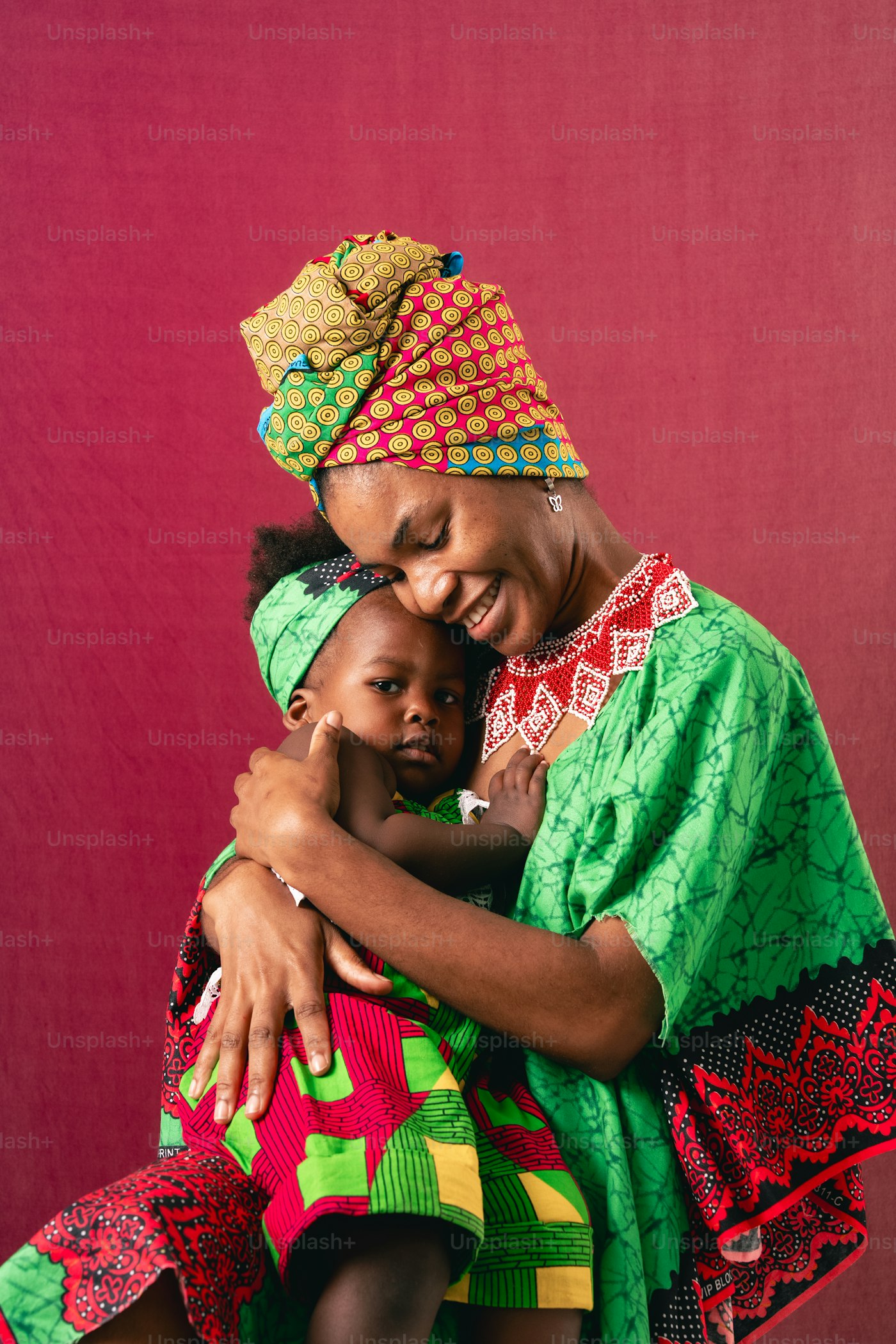 A mother holding her baby, both smiling